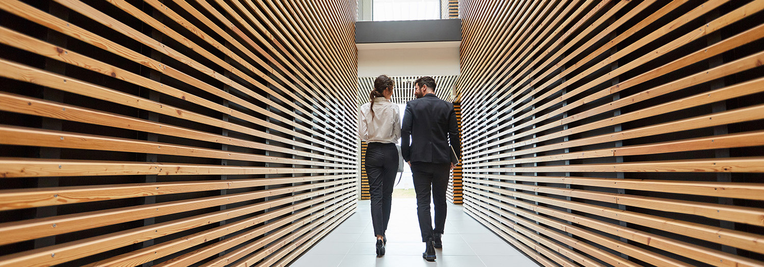 Man and woman walking down a hallway